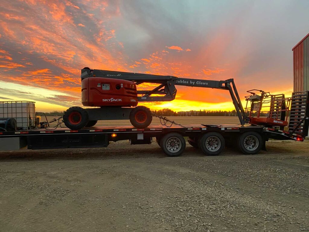 sunset behind semi-truck Clews man-lift